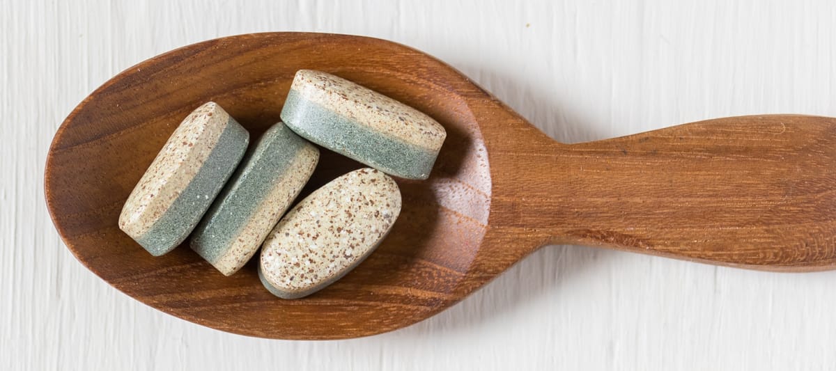 Vitamins in a wooden spoon